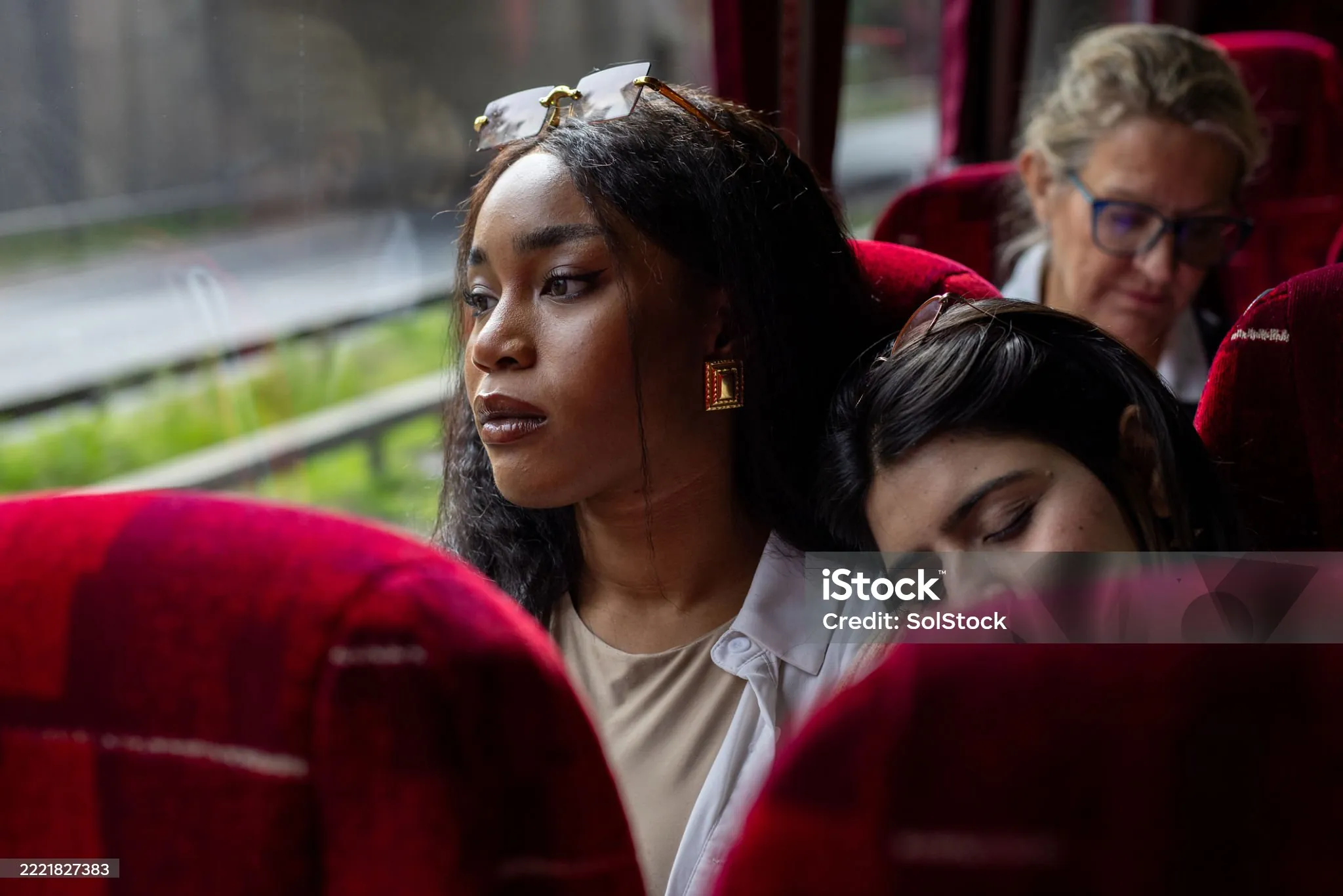Two tired women on a bus.
