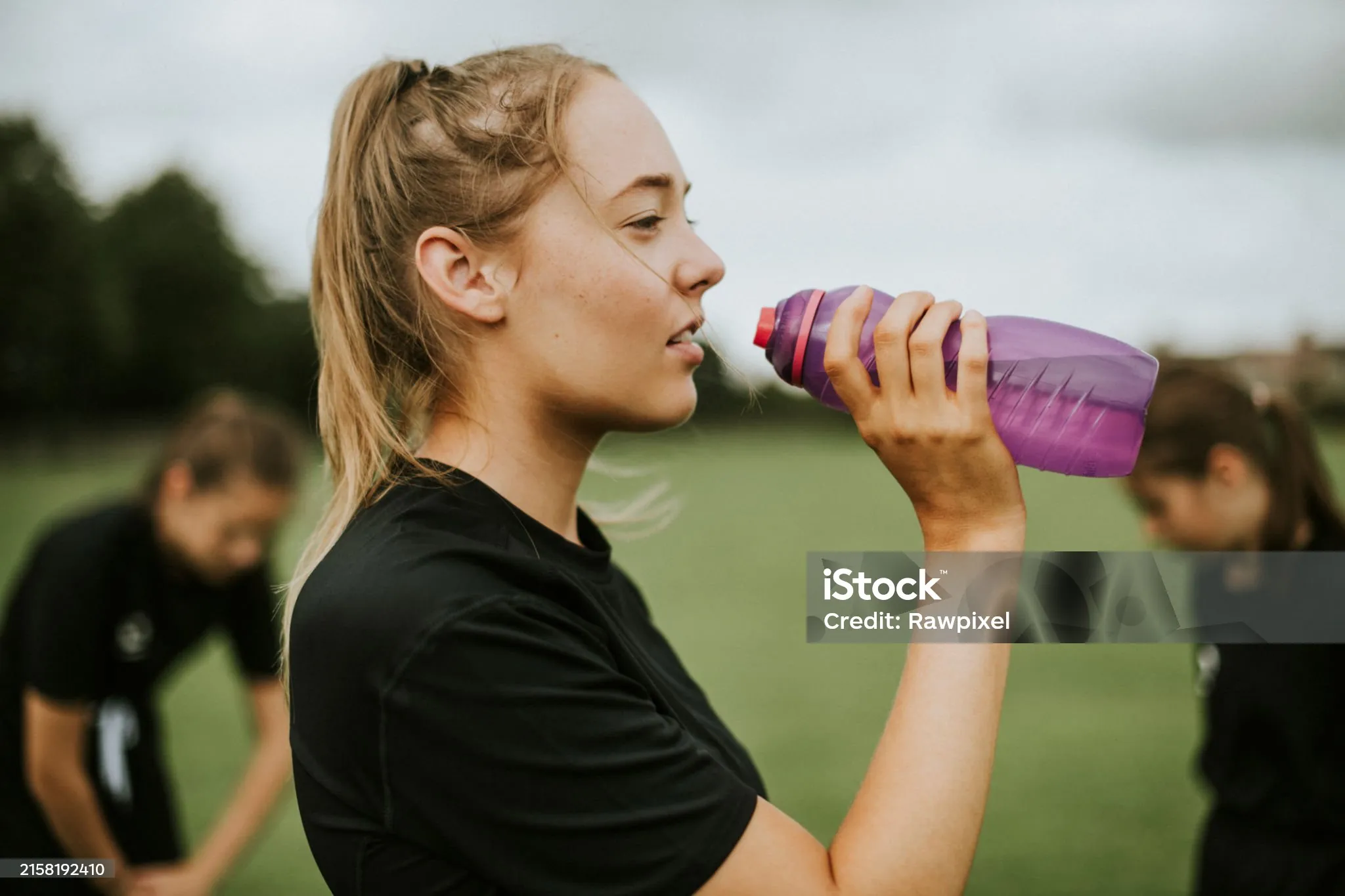 A young athlete is resting taking a recovery supplement.