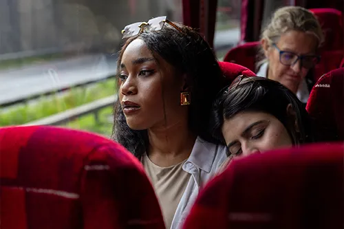 Two tired women on a bus.