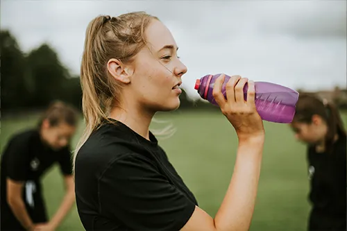 A young athlete is resting taking a recovery supplement.